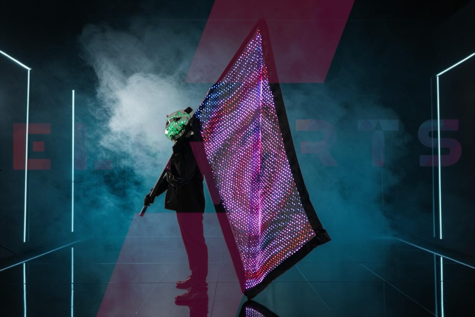LED flag lit purple and pink, swept through stage smoke by a performer